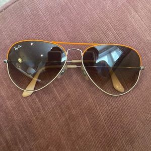 Ray Bans with orange trim, silver frame, gradient lenses